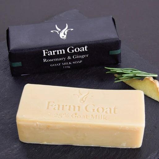 Goat Milk rosemary and ginger soap bar sitting with piece of ginger in front of packaging