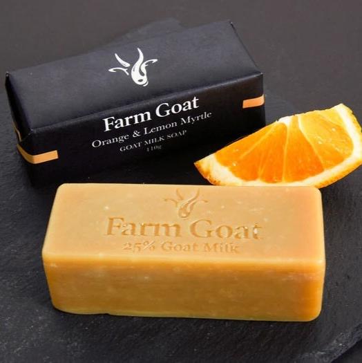 Orange and lemon myrtle soap bar with slice of orange to show ingredients