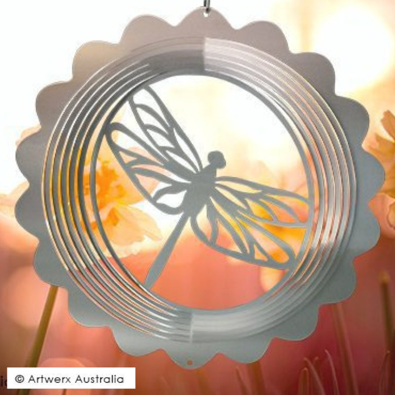 Wind spinner of a dragonfly on backgound  with flowers