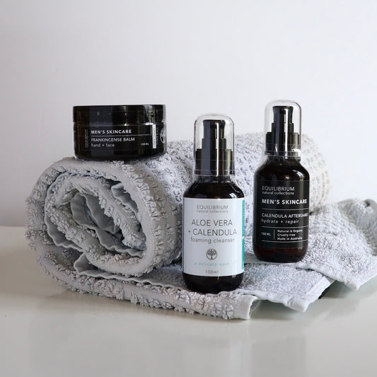 equilibrium mens skincare pack including hand & face balm, foaming cleanser in bottle and aftershave in bottle sitting on a towel