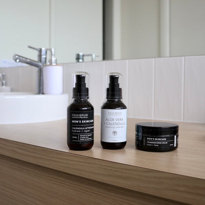 equilibrium mens skincare pack including hand & face balm, foaming cleanser in bottle and aftershave in bottle sitting on bathroom counter