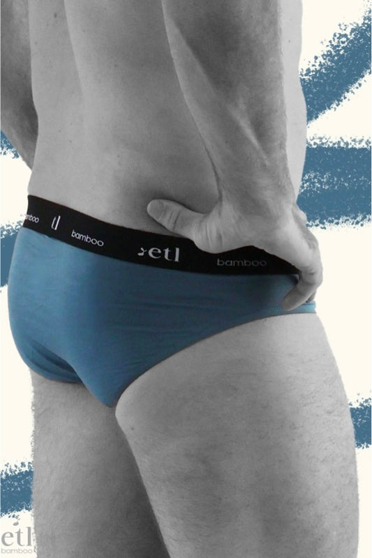 Men's blue underwear briefs on male model side view