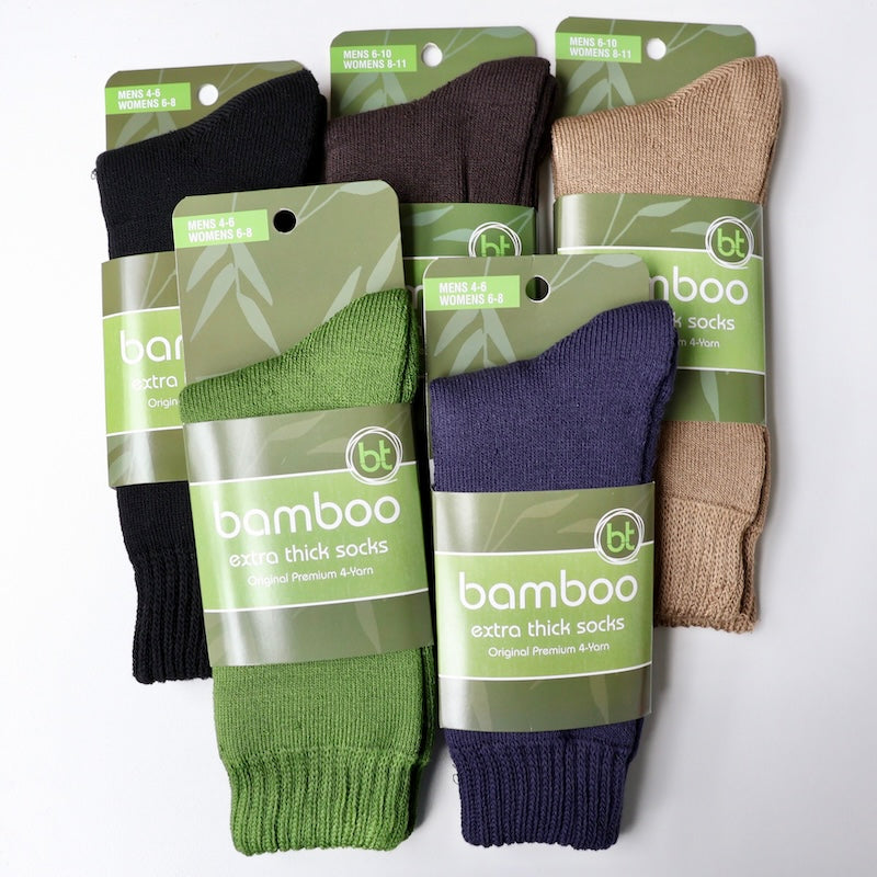 navy, green, brown, black and natural coloured extra thick socks on a white background